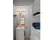 Well-lit bathroom with vanity, storage shelves, and doorway leading to the bedroom featuring a gold trimmed mirror at 1670 Oakland St, Aurora, CO 80010