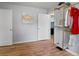 This room features a unique clothing rack and refinished hardwood floors at 1670 Oakland St, Aurora, CO 80010
