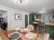 Dining room seamlessly connects to the kitchen, featuring a stylish light fixture at 1670 Oakland St, Aurora, CO 80010