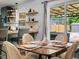 Dining room featuring a wood table with seating for four and a sliding glass door at 1670 Oakland St, Aurora, CO 80010