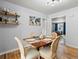 Charming dining area with wood table, seating and seamless living room access at 1670 Oakland St, Aurora, CO 80010