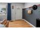 Stylish entryway featuring hardwood floors, accent wall, decorative wall hangings, and natural light from a nearby window at 1670 Oakland St, Aurora, CO 80010