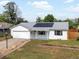 Charming single-story home with solar panels, a well-maintained lawn, and an attached garage at 1670 Oakland St, Aurora, CO 80010