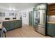 Open kitchen featuring a butcher block island countertop, stainless steel fridge and dining area access at 1670 Oakland St, Aurora, CO 80010