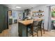 Spacious kitchen with butcher block countertops, a kitchen island and stylish bar seating at 1670 Oakland St, Aurora, CO 80010