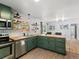 Bright kitchen boasts butcher block countertops, stainless steel appliances, and green cabinetry at 1670 Oakland St, Aurora, CO 80010