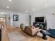 Bright living room featuring hardwood floors, recessed lighting, and modern furniture, creating a cozy and inviting space at 1670 Oakland St, Aurora, CO 80010