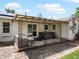 Relaxing covered patio includes seating, a hot tub, and convenient sliding door access at 1670 Oakland St, Aurora, CO 80010