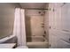 Cozy tub/shower combo bathroom, features a tiled surround and practical shower curtain for a clean, functional space at 12535 S Beaver Creek Way, Parker, CO 80134
