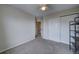 Bedroom with neutral walls, closet, and carpet flooring at 12535 S Beaver Creek Way, Parker, CO 80134