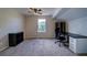 Bright bedroom featuring neutral walls, plush carpet, ceiling fan and a dedicated office/work space at 12535 S Beaver Creek Way, Parker, CO 80134