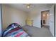 Bedroom with neutral walls, carpet, and adjoining bathroom at 12535 S Beaver Creek Way, Parker, CO 80134