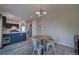 Dining area adjacent to the kitchen with a wooden table and white chairs at 12535 S Beaver Creek Way, Parker, CO 80134