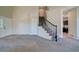 Inviting entryway features a staircase with black railing and access to a modern kitchen at 12535 S Beaver Creek Way, Parker, CO 80134