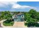 Aerial view of a blue two-story home with a three-car garage and lush landscaping at 12535 S Beaver Creek Way, Parker, CO 80134
