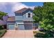 Charming blue two-story home with a three-car garage and well-maintained landscaping at 12535 S Beaver Creek Way, Parker, CO 80134