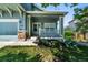 Inviting covered front porch with white railings and stone accents at 12535 S Beaver Creek Way, Parker, CO 80134