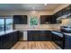 Spacious kitchen featuring dark cabinetry, stainless steel appliances, and natural light at 12535 S Beaver Creek Way, Parker, CO 80134