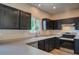 Modern kitchen with dark cabinetry, stainless steel appliances, and ample counter space at 12535 S Beaver Creek Way, Parker, CO 80134