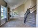 Living room showcasing high ceilings, fireplace, and staircase with dark metal railings at 12535 S Beaver Creek Way, Parker, CO 80134