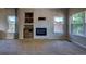 Bright living room featuring a fireplace with white brick surround and built-in shelves at 12535 S Beaver Creek Way, Parker, CO 80134