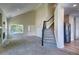 Living room with cathedral ceilings, staircase with black railing, and modern stainless steel refrigerator at 12535 S Beaver Creek Way, Parker, CO 80134