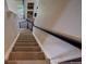 Carpeted staircase with a dark railing leading to the upper level of the home at 12535 S Beaver Creek Way, Parker, CO 80134