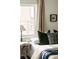 Bedroom featuring cozy bed with accent pillows, and decor near bright window with curtains at 4422 W 27Th Ave, Denver, CO 80212