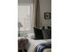 Bright bedroom featuring large windows, a comfortable bed with decorative pillows, and a side table with a lamp at 4422 W 27Th Ave, Denver, CO 80212