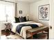 Comfortable bedroom with a cozy bed, stylish bedding, decor, and dark hardwood flooring at 4422 W 27Th Ave, Denver, CO 80212