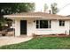 Charming home with a well-manicured lawn, brick accents, and a cozy outdoor seating area at 4422 W 27Th Ave, Denver, CO 80212