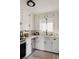Bright kitchen featuring white cabinets, countertops, and a classic checkered floor at 4422 W 27Th Ave, Denver, CO 80212