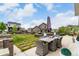 Landscaped backyard featuring a dining table, manicured lawn, and partial fencing at 5964 E 141St Ave, Thornton, CO 80602