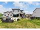 Large backyard with patio, outdoor dining, lush lawn, and beautifully designed hardscape at 5964 E 141St Ave, Thornton, CO 80602