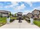 Spacious backyard featuring stone planters, a fire pit, manicured lawn, and wood fencing at 5964 E 141St Ave, Thornton, CO 80602