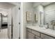 Bright bathroom with a white basin sink, grey cabinets, framed inspirational wall art, and neutral decor at 5964 E 141St Ave, Thornton, CO 80602