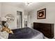 Neutral bedroom with dark furniture, gray bedding, and decor at 5964 E 141St Ave, Thornton, CO 80602