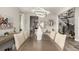Open-concept dining area with modern chandelier and views to an elegant stairway at 5964 E 141St Ave, Thornton, CO 80602