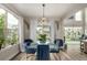 Stylish dining area with a modern light fixture and large windows at 5964 E 141St Ave, Thornton, CO 80602