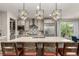 Bright kitchen boasts a large island, stainless steel appliances, and modern lighting at 5964 E 141St Ave, Thornton, CO 80602