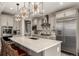 Spacious kitchen featuring stainless steel appliances and stylish, modern light fixtures at 5964 E 141St Ave, Thornton, CO 80602