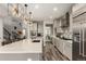 Open kitchen design featuring stainless steel appliances, large island, and bar stool seating at 5964 E 141St Ave, Thornton, CO 80602