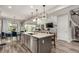 Kitchen island with a dishwasher, sink, and barstool seating provides a social cooking experience at 5964 E 141St Ave, Thornton, CO 80602