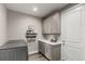 Laundry room featuring a stainless steel washer, gray cabinets, granite counters, and neutral decor at 5964 E 141St Ave, Thornton, CO 80602