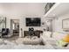 Spacious living room with plush seating and a view to an open floor plan with a 2nd floor balcony at 5964 E 141St Ave, Thornton, CO 80602
