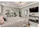 This primary bedroom features a king bed, mirrored decor, and flows into the ensuite bath area at 5964 E 141St Ave, Thornton, CO 80602