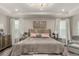 Cozy main bedroom with a tray ceiling, hardwood floors, and neutral decor at 5964 E 141St Ave, Thornton, CO 80602