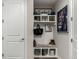 Mudroom with decorative shelving, hooks, a fur-lined bench, and framed wall art at 5964 E 141St Ave, Thornton, CO 80602