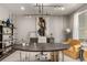 Office featuring a large round wood table, mustard colored armchair, modern chandelier, and decorative shelving at 5964 E 141St Ave, Thornton, CO 80602