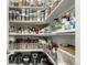 Walk-in pantry with ample shelving and storage space for groceries and kitchen appliances at 5964 E 141St Ave, Thornton, CO 80602